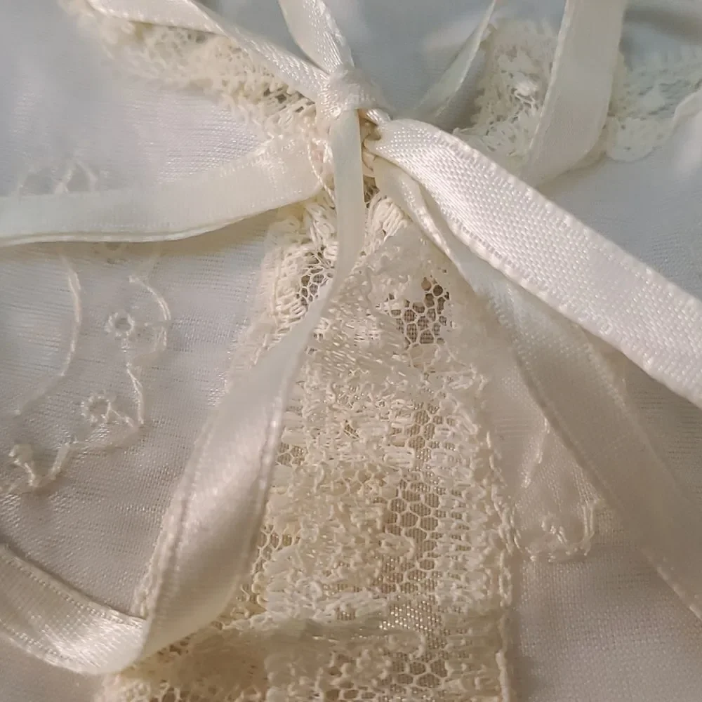 Vintage baby dress with jacket. Trimmed in lace with tie. The jacket has enbroid